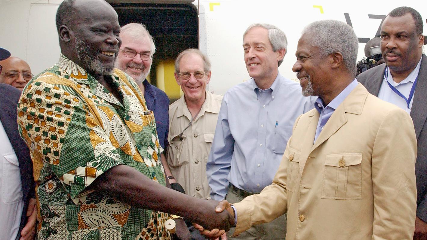 John Garang (left), Chairman of the Sudan People's Liberation Movement (John Garang ), welcoming Secretary-General Kofi Annan upon his arrival in Rumbek, southern Sudan.