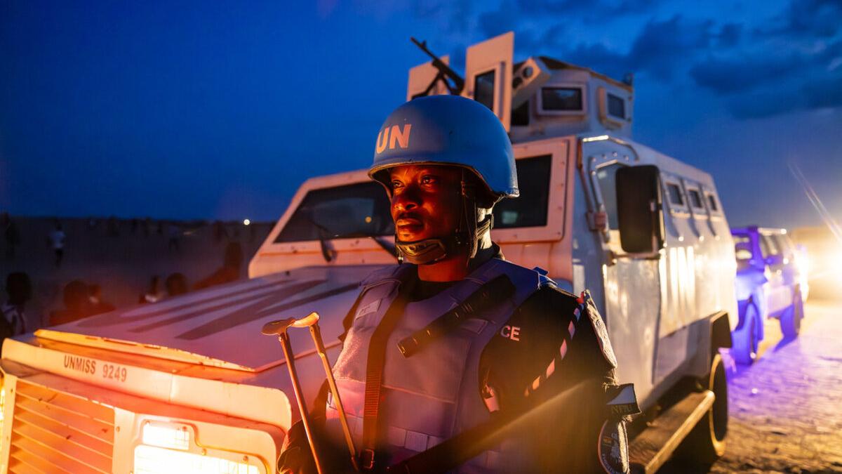 Police Officer in front of a patrol car