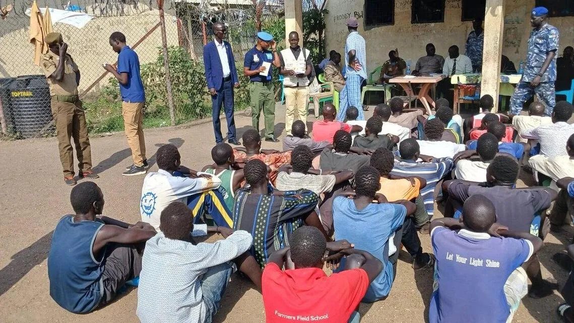 group of people sitting on the ground.