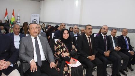 people on a bench looking on the stage