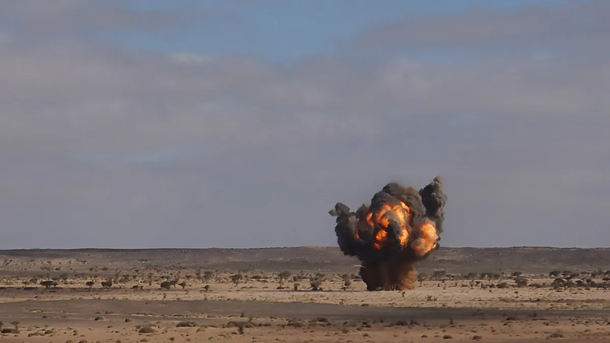 an explosion with smoke in a field