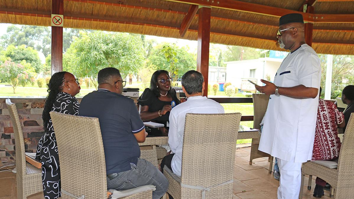 Director RSCE, Mr. Paulin Djomo (standing) talks to Chief LARRMU,  Elise Metougue and some RSCE staff members on the importance of the ISO Awareness Clinic.