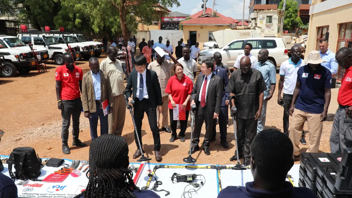 Toshiō Odagiri, Ambassador of Japan to South Sudan, Tomohiro Suzuki, Senior Representative of the JICA South Sudan Office, alongside representatives of UNMAS and the NMAA, view the operational equipment, vehicles and motorbikes officially handed over to strengthen national mine action operations.