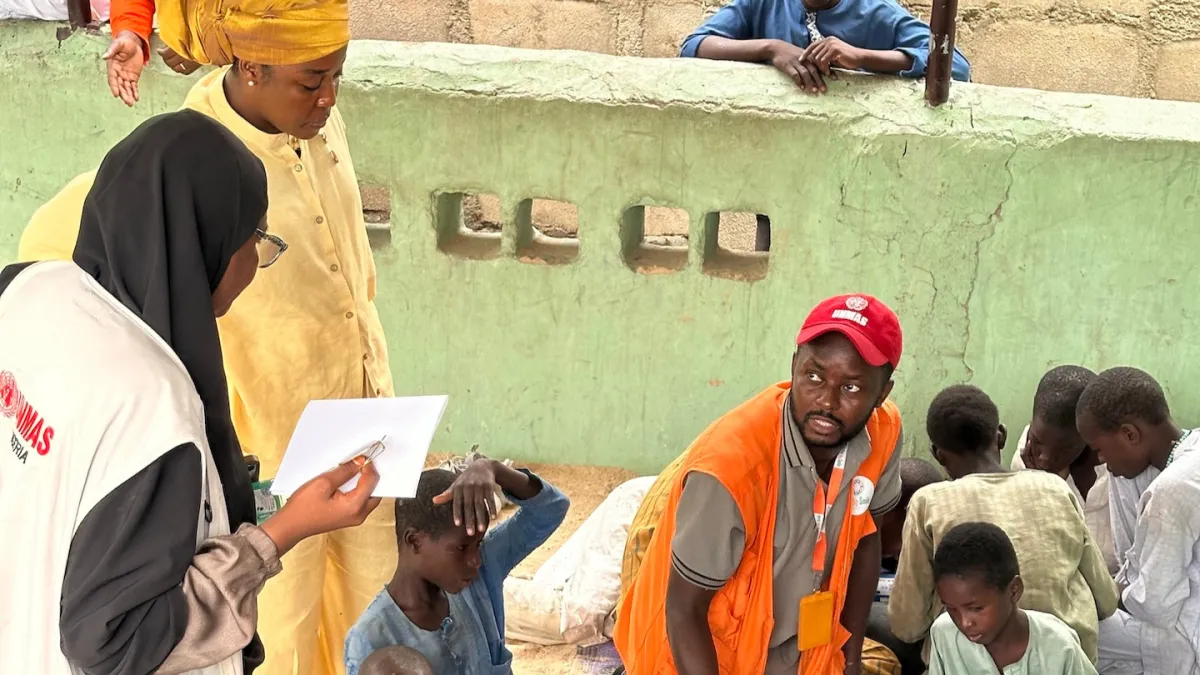 Maryam meets with children during an Explosive Ordnance Risk Education (EORE) session in Borno, Nigeria. 