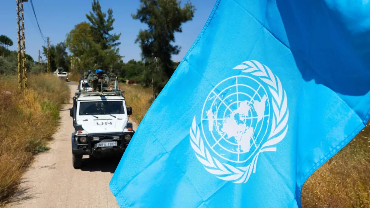 un flag with patrol vehicle in the background