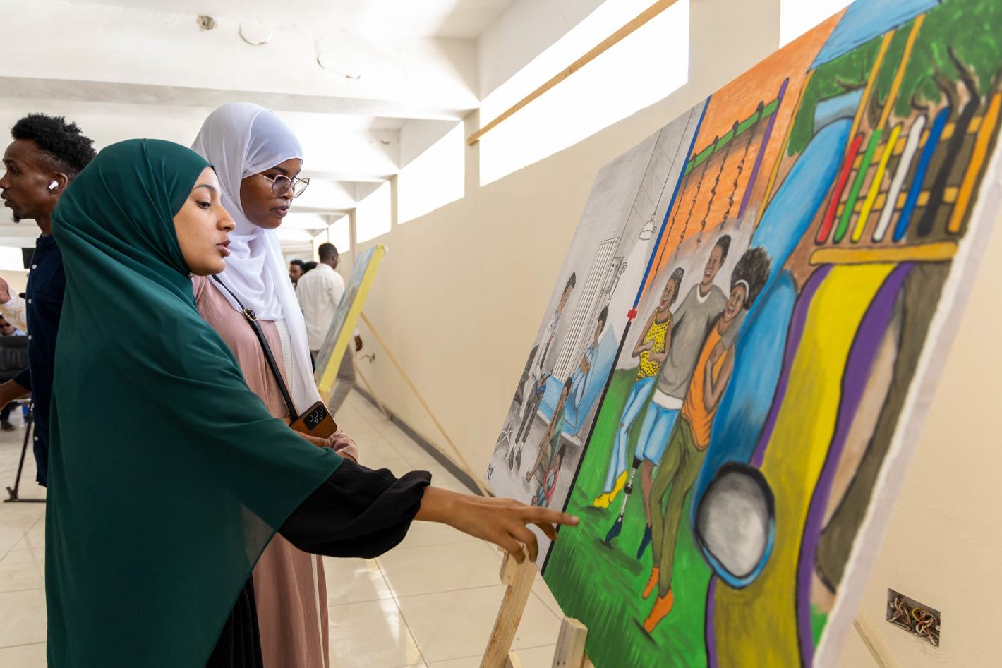 Guests view art paintings by Somali artists at an event commemorating International Universal Health Coverage Day at the National Museum in Mogadishu, Somalia, on 18 December 2024.