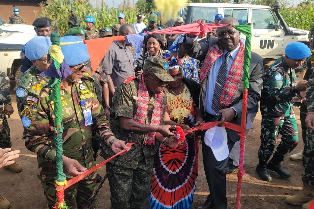 Representatives cut a commemorative ribbon together.
