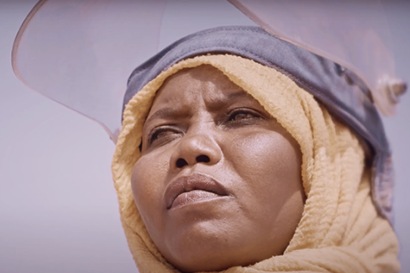 a woman with a hijab and a protective mask