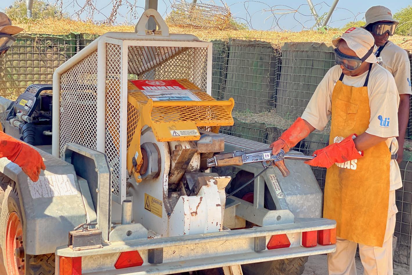 a man is destucting a weapon with a machine