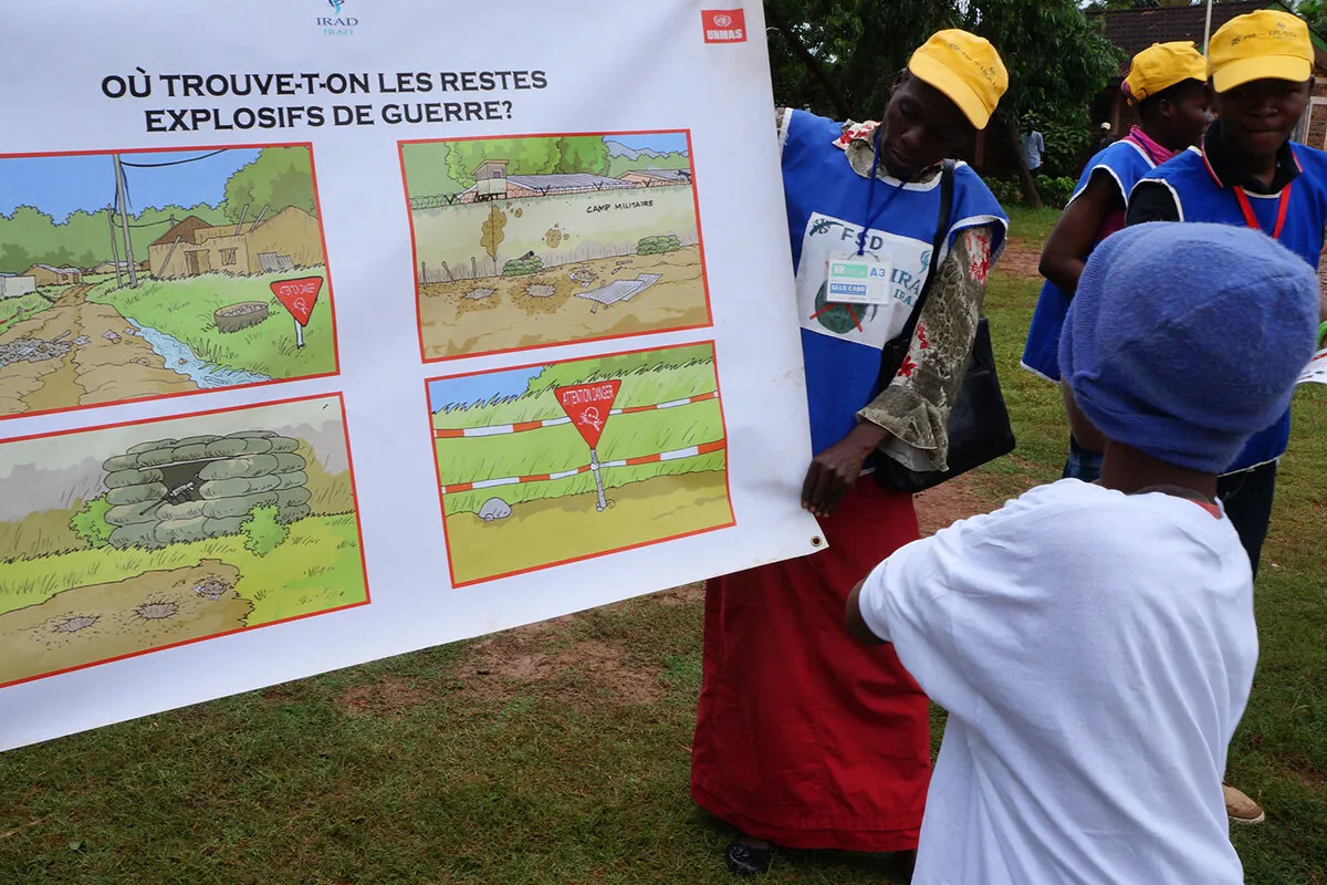 a woman is presenting a poster to a kid