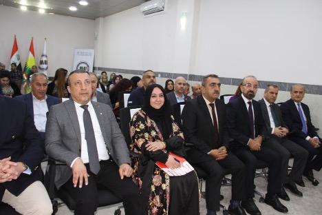 people on a bench looking on the stage