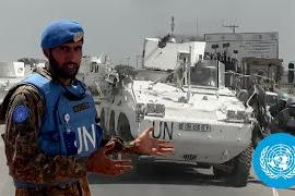 Peacekeeper standing in front of vehicle