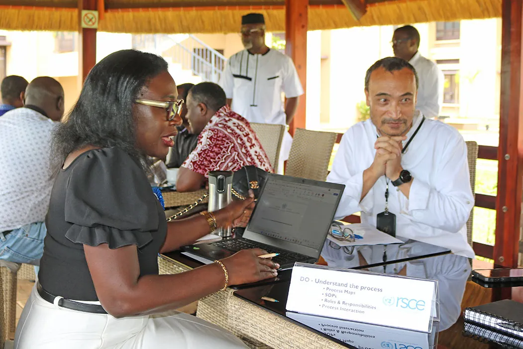 Chief LARRMU, Elise Metougue takes International Payroll and Benefits Service Line Manager, Manaswee Vaidya, through his checklist for ISO 9001:2015 documentation Chief LARRMU, Elise Metougue takes International Payroll and Benefits Service Line Manager, Manaswee Vaidya, through his checklist for ISO 9001:2015 documentation