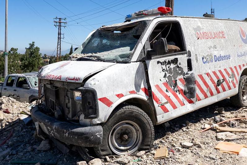A damaged, non-operational ambulance stands near destroyed buildings on a street heavily affected by the recent hostilities, close to the government hospital in Tibnin, South Lebanon. Tibnin, South Lebanon