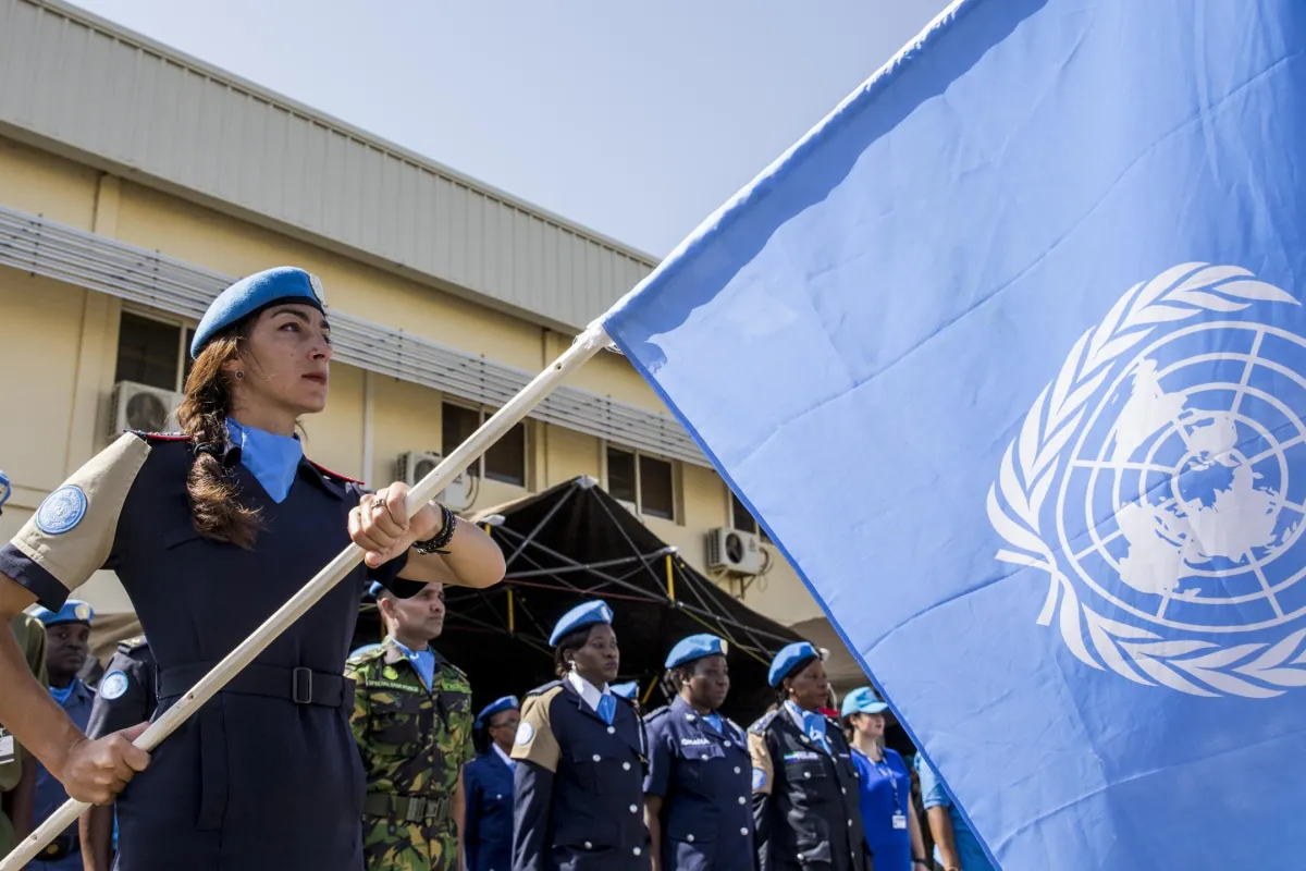 UN police officer holding un UN flag
