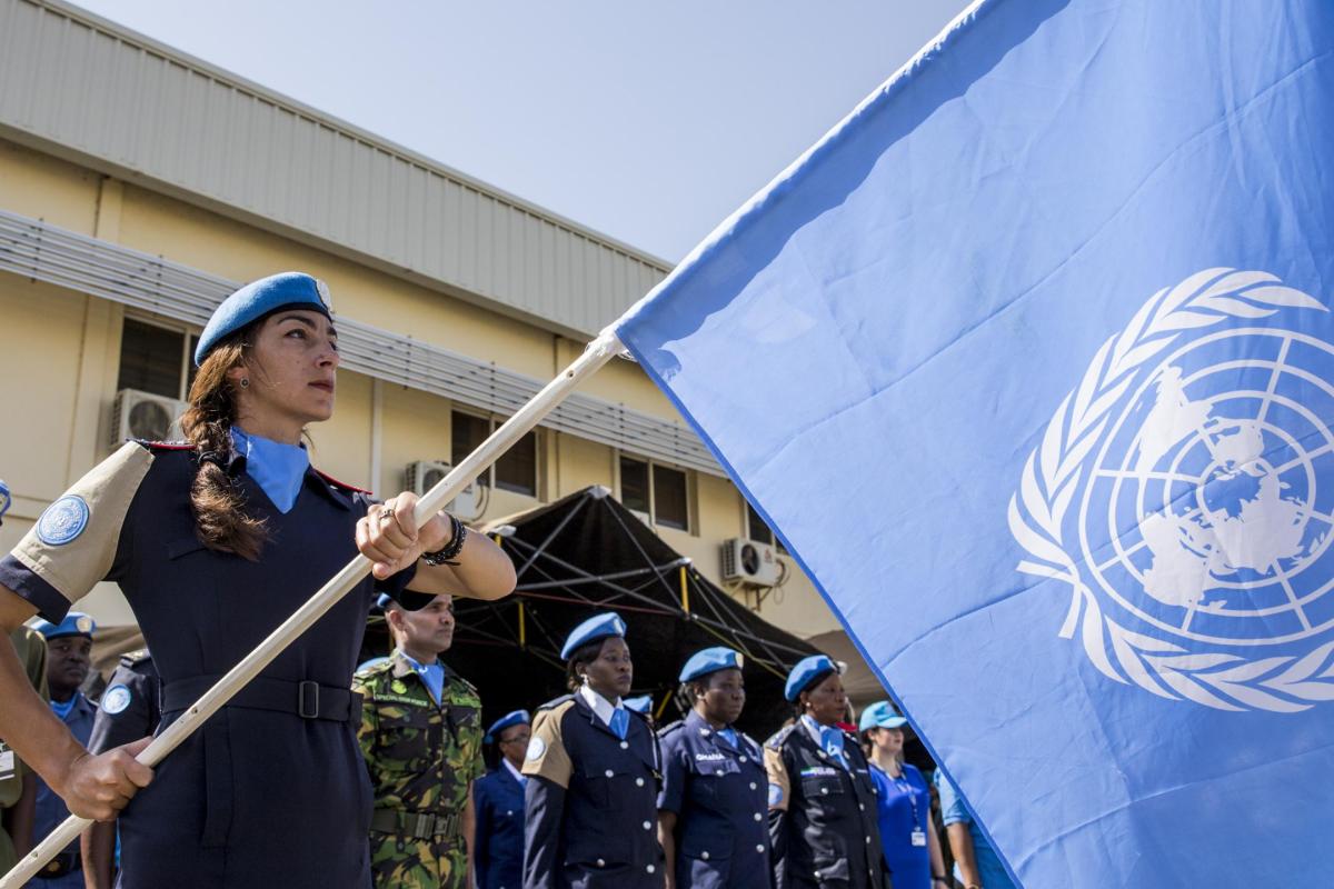 UN police officer holding un UN flag