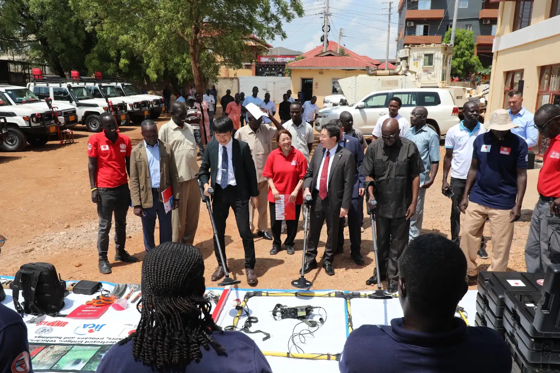Toshiō Odagiri, Ambassador of Japan to South Sudan, Tomohiro Suzuki, Senior Representative of the JICA South Sudan Office, alongside representatives of UNMAS and the NMAA, view the operational equipment, vehicles and motorbikes officially handed over to strengthen national mine action operations.