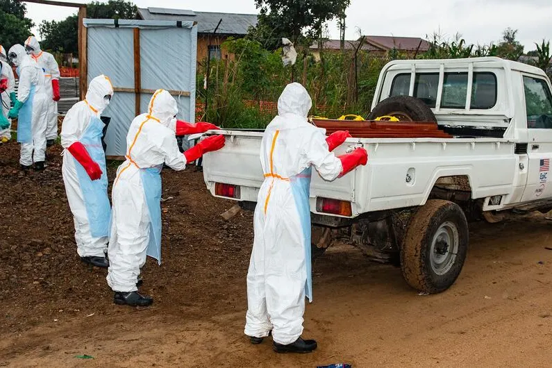 Members of a community team prepare to conduct burial of a person who died from Ebola in the eastern DR Congo