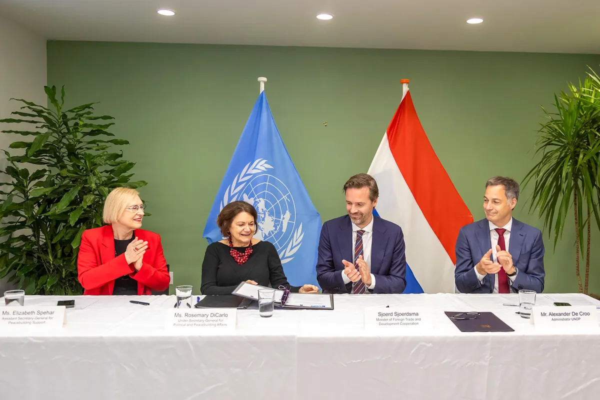 Participants applaud following the signing of a multi-year agreement through which the Netherlands pledged support to United Nations work on peace and security.