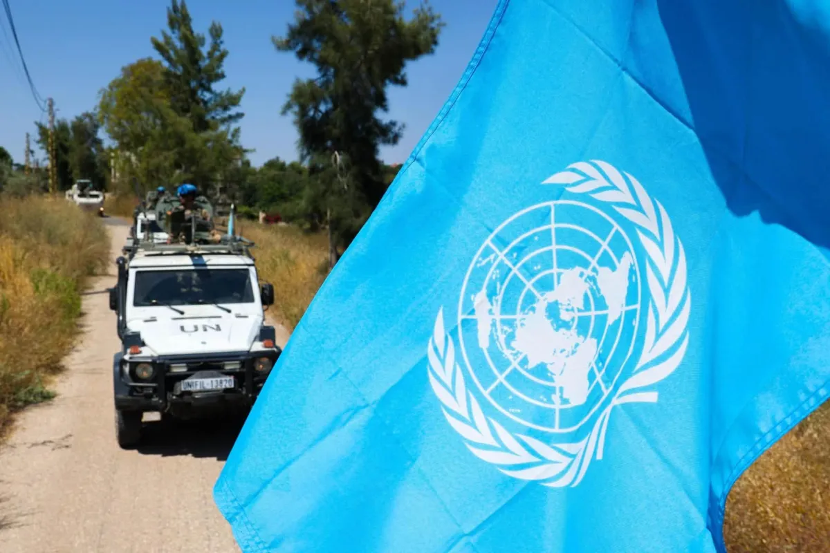 un flag with patrol vehicle in the background