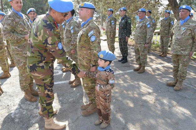 Major General Humayun of Bangladesh, Force Commander of UN Peacekeeping Force in Cyprus (UNFICYP) shaking hands of boy (UN peacekeeper-in-training) at sector 1 medal parade on 31 January 2018, Cyprus.  Photo: UNFICYP/Robert Schütz